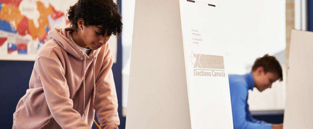 Two students voting in mock election.