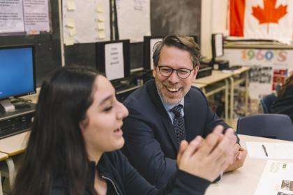 Elections Canada's CEO laughing with a student.