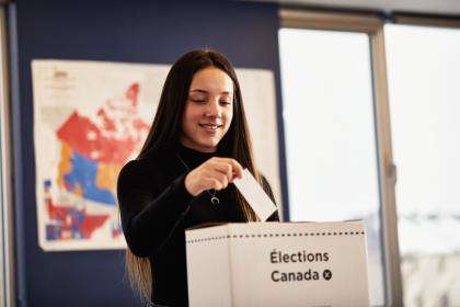 Student casting a ballot.