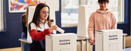 Students voting in mock election. 