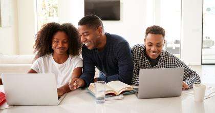 A father and children working at the computer