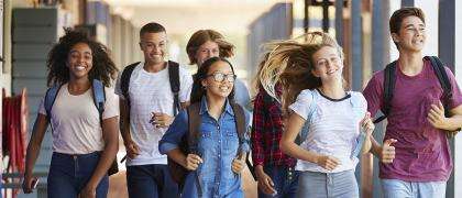 Joyful students walking in corridor