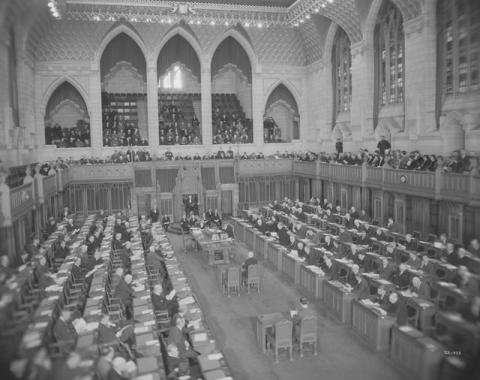 Black and white photo of the House of Commons Chamber.