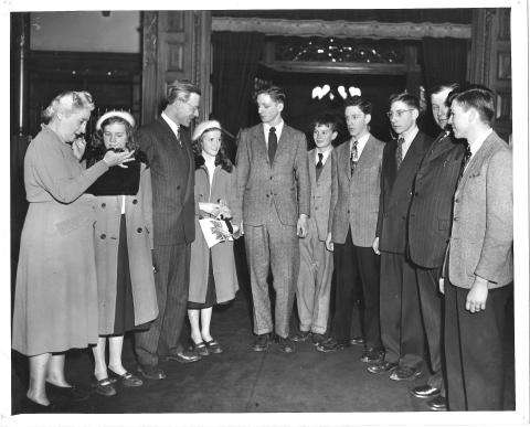 Black and white photograph showing a group of young people standing together with Agnes Macphail.