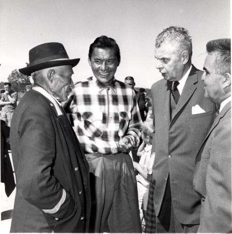 Black and white photo of John Diefenbaker with Chief Jimmy Bruneau of Rae, Chief Joe Sangris, and the Mayor of Yellowknife, Northwest Territories, in discussion.