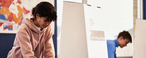 Two students voting in mock election. 