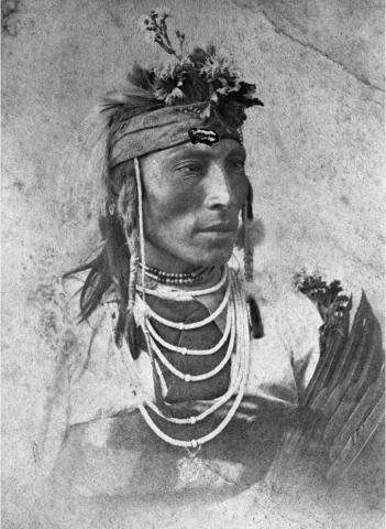 Black and white portrait of a First Nations man from the Plains.