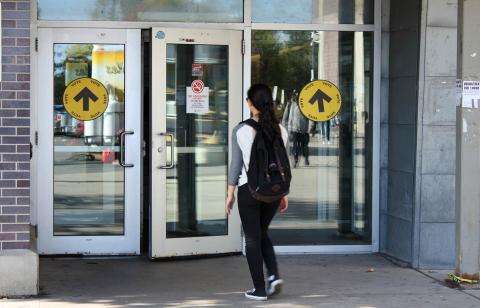 person walking into a polling station person walking into a polling station